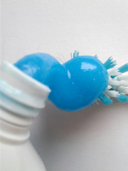 A drop of toothpaste. Sky blue color. White background, no isolation.