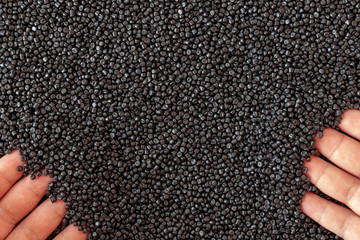 Close-up of plastic polymer granules. hand hold Polymer pellets. polymer plastic. compound polymer.