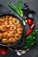 .Stuffed peppers with rice, meat and spices in a dark pan on a dark background top view
