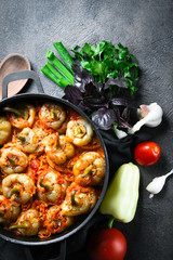 .Stuffed peppers with rice, meat and spices in a dark pan on a dark background top view