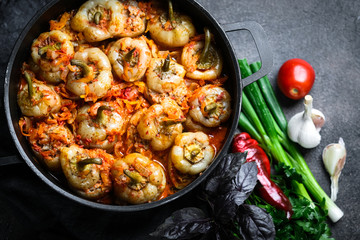 .Stuffed peppers with rice, meat and spices in a dark pan on a dark background top view