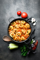 .Stuffed peppers with rice, meat and spices in a dark pan on a dark background top view