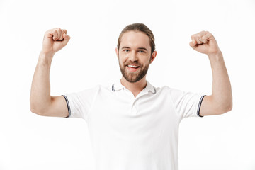 Fototapeta premium Happy young handsome bearded man make winner gesture.
