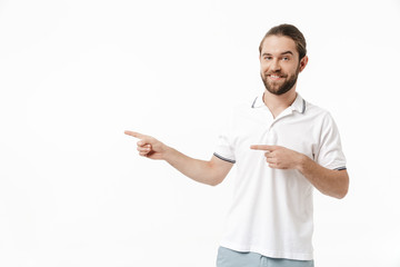 Bearded man posing isolated over white wall background pointing.