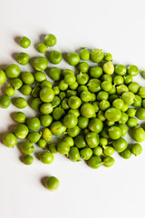 Green fresh scattered peas on a white background.