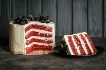 Red Velvet Cheesecake. Tasty homemade american dessert with berries on a dark background.
