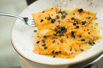 Truffle ravioli on a white plate