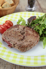 Fototapeta na wymiar grilled ground beef steak and salad on a plate