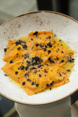 Truffle ravioli on a white plate