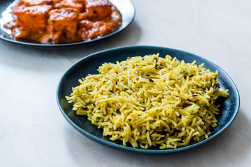 Indian Food Jeera Zira Rice Basmati Pilaf or Pilav with Paneer Butter Tikka Masala / Cheese Cottage Curry.