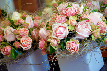 Romantic Floral Table Arrangements of Soft Pink Roses in a Ceramic Pot. Designer Wedding Reception Flowers.