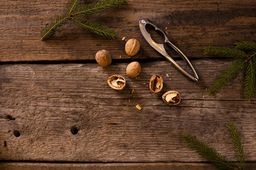 Walnuts and nutcracker on rustic wooden background. copy space for text.
