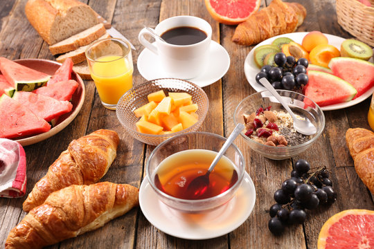 healthy breakfast with coffee, tea, bread, muesli and fruits