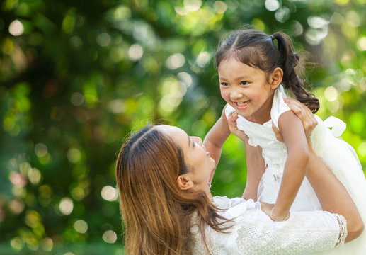 closup portrait of happy mother and daughter