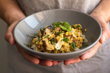 bulgur with vegetables and meat on a plate close-up