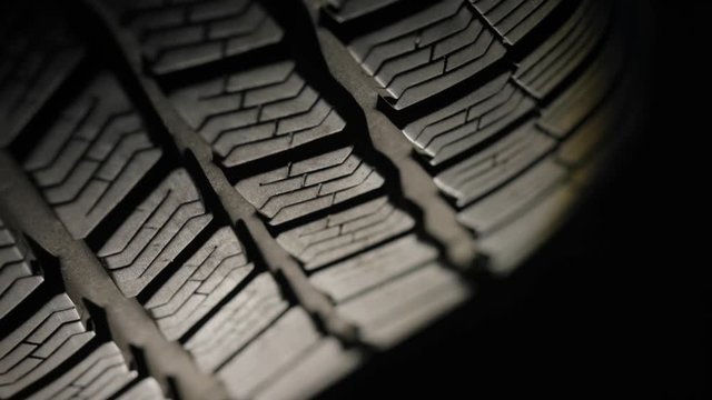 Spinning tire of a car, slowing down slowly coming to a stop