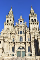 Fototapeta na wymiar Cathedral, baroque facade and towers from Plaza del Obradoiro with blue sky. Santiago de Compostela, Spain.