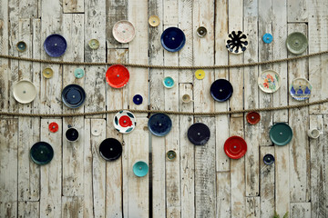 colorful funny plates on wooden wall, background, texture
