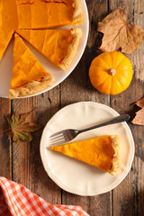 homemade pumpkin pie and slices, top view