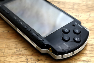 Used and old portable game console on a table.