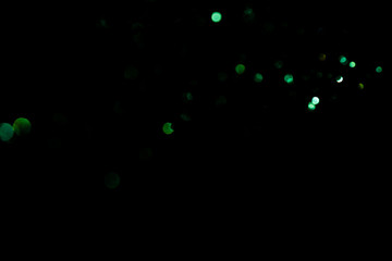 Abstract Blurred image background green bokeh with black background.