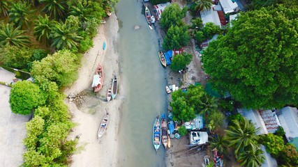 River and Patong Thailand with boats and a small village