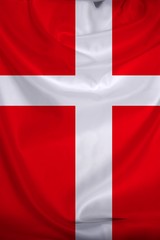 Fototapeta premium beautiful photo of the colored national flag of the modern state of Denmark on textured fabric, concept of tourism, emigration, economics and politics, close up