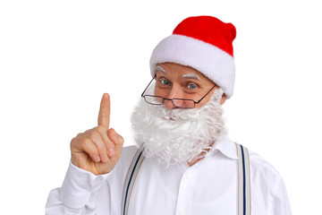 Fototapeta na wymiar man in suspenders in santa claus costume with beard, in a hat shows a finger, christmas concept, on a white background