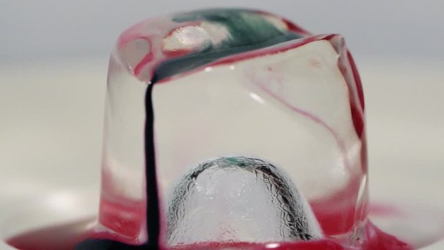 Slow motion paint falling on ice cube shot in macro. Sony a7iii