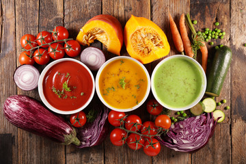 assortment of vegetable soup with ingredient, top view- wood background