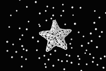 Christmas white star for tree decoration on black background.
