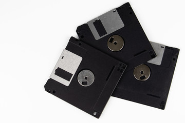 Old floppy disks on a white background.
