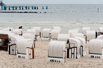Hooded beach chairs in Baltic sea beach a cloudy day of Summer. Sellin, Rugen Island. Germany