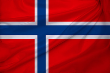 beautiful photo of the colored national flag of the modern state of Norway on textured fabric, concept of tourism, emigration, economics and politics, close up