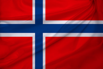 Fototapeta premium beautiful photo of the colored national flag of the modern state of Norway on textured fabric, concept of tourism, emigration, economics and politics, close up