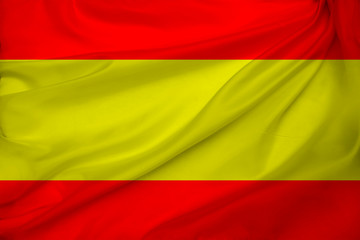 photo of the beautiful colored national flag of the modern state of Spain on a textured fabric, concept of tourism, economics and politics, closeup