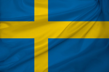 photo of the beautiful colored national flag of the modern state of Sweden on a textured fabric, concept of tourism, emigration, economics and politics, closeup