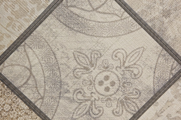 Light beige ceramic tiles with pattern on the floor