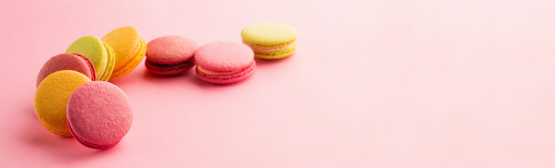 Sweet macarons on pink background