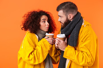 Frozen loving couple holding coffee.