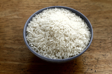 Bowl of raw rice on a table