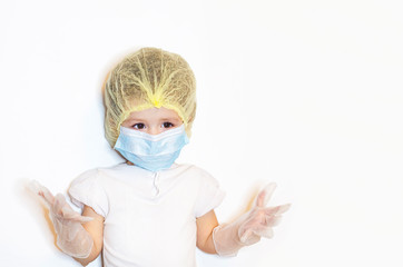 Smiling little girl is playing doctor isolated. a child in a medical uniform, hat, mask, latex gloves. baby in white uniform shows her hands. healthcare. copy space, text