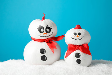 Cute snowmans with red bow on blue background, space for text