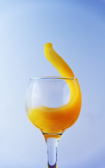 Glass glass with orange juice with frozen flashes and drops