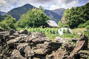 Fototapeta na wymiar A stone fence separating plots high in the mountains 