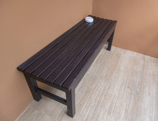 wooden brown bench for smoking area at hotel balcony