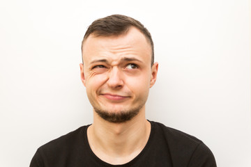 Fototapeta premium emotion wink, young man on a white background, human emoji