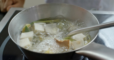 Cook Tom Yum soup in kitchen