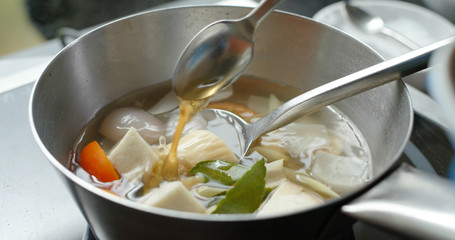 Cooking tom yum soup in kitchen