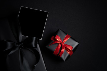 Top view of free space for text with black gift box isolated on black background.